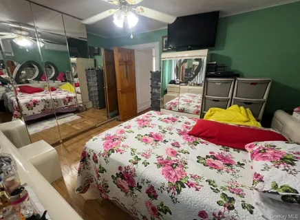 a bedroom with furniture and a flat screen tv