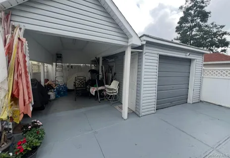 a view of a garage with clothes and shoes