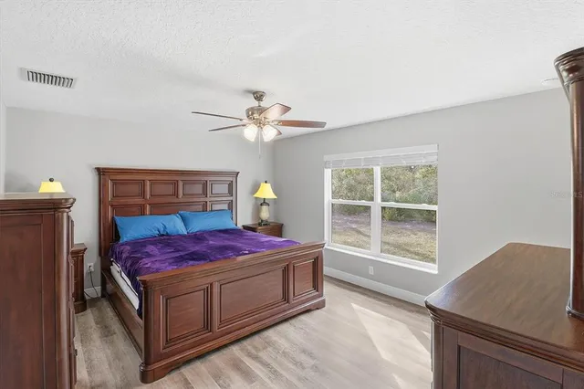 a living room with a bed and next to a window