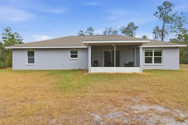 a bedroom with a bed and glass window