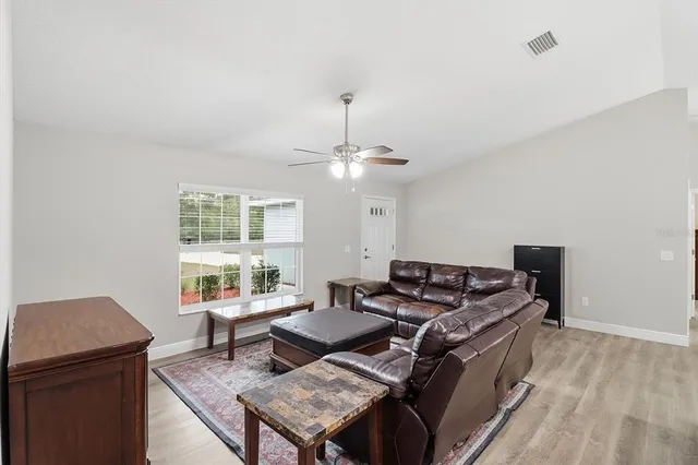 a living room with furniture a chandelier and a table