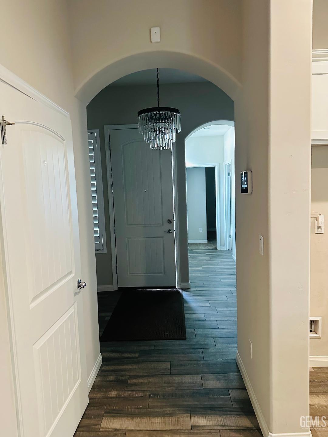Undisclosed Address Bakersfield, CA 93314 - Photo 18 of 32 a view of a hallway with wooden floor and staircase