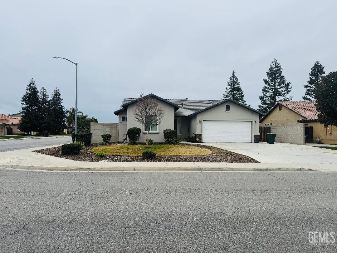 Undisclosed Address Bakersfield, CA 93314 - Photo 2 of 32 a front view of a house with a yard