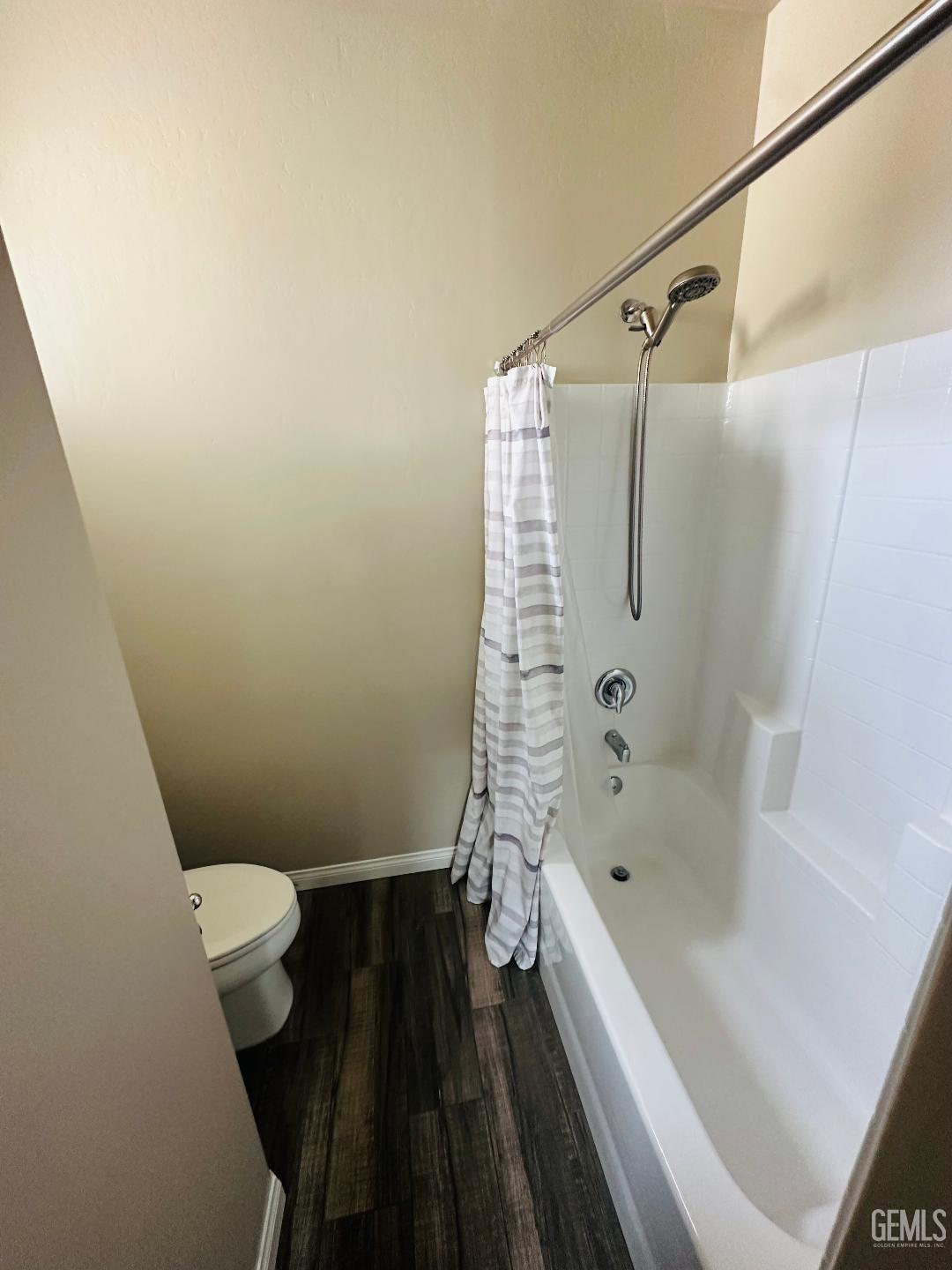 Undisclosed Address Bakersfield, CA 93314 - Photo 32 of 32 a bathroom with a bathtub and a toilet