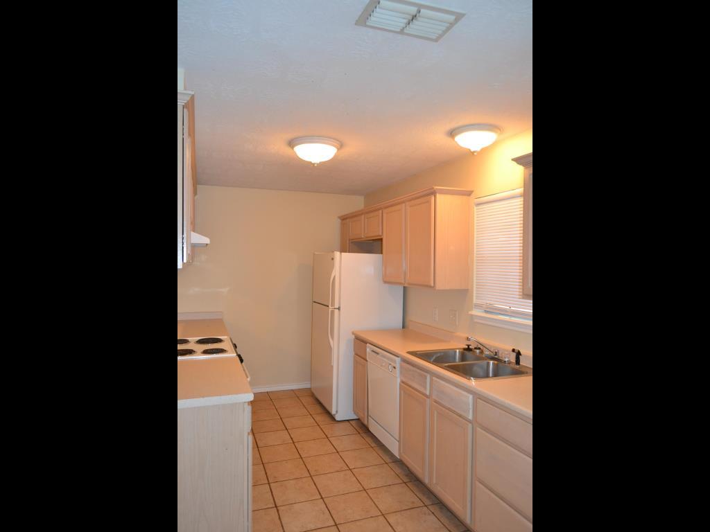 807 Welsh Avenue College Station, TX 77840 - Photo 4 of 11 a kitchen with a sink and a stove top oven