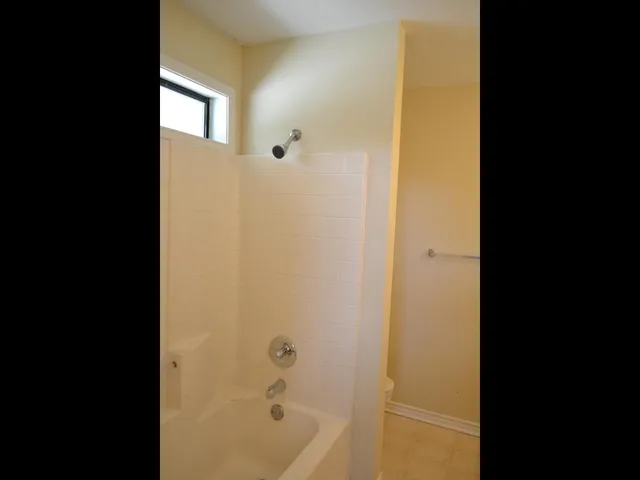 a bathroom with a shower and a sink