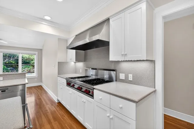 a view of a room with wooden floor and outdoor view