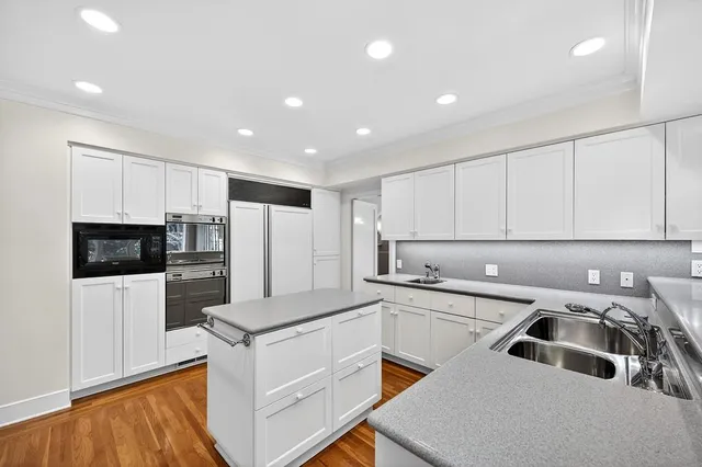 a view of empty room with wooden floor and fireplace