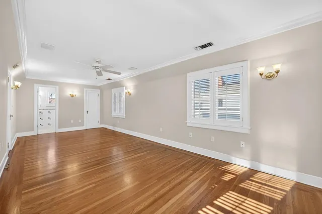 a view of kitchen with wooden floor and electronic appliances