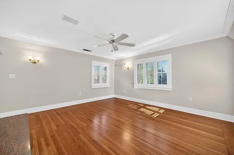 a backyard of a house with plants and large trees