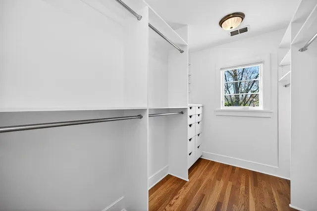 a front view of a house with a yard and fountain