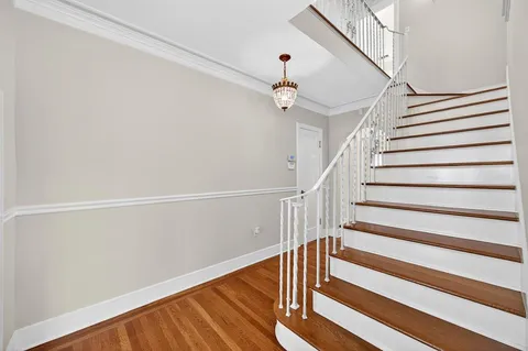 a view of empty room with wooden floor and window