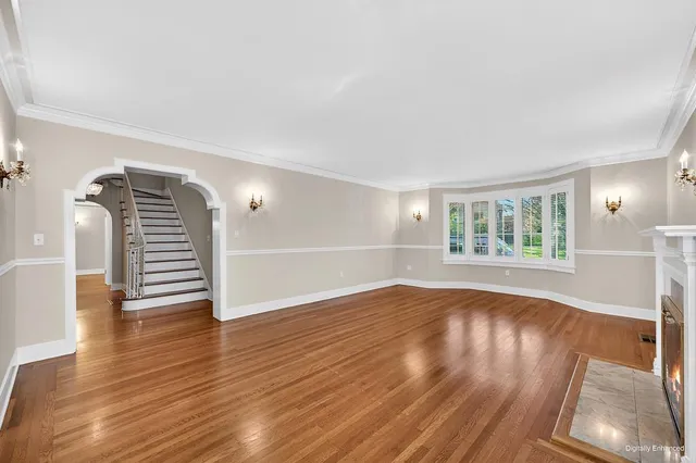a view of a room with wooden floor and windows