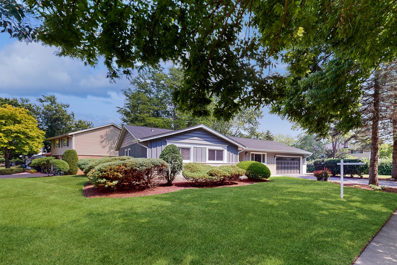 1617 Birch Road Northbrook, IL 60062 - Photo 2 of 32 a front view of a house with a garden and trees