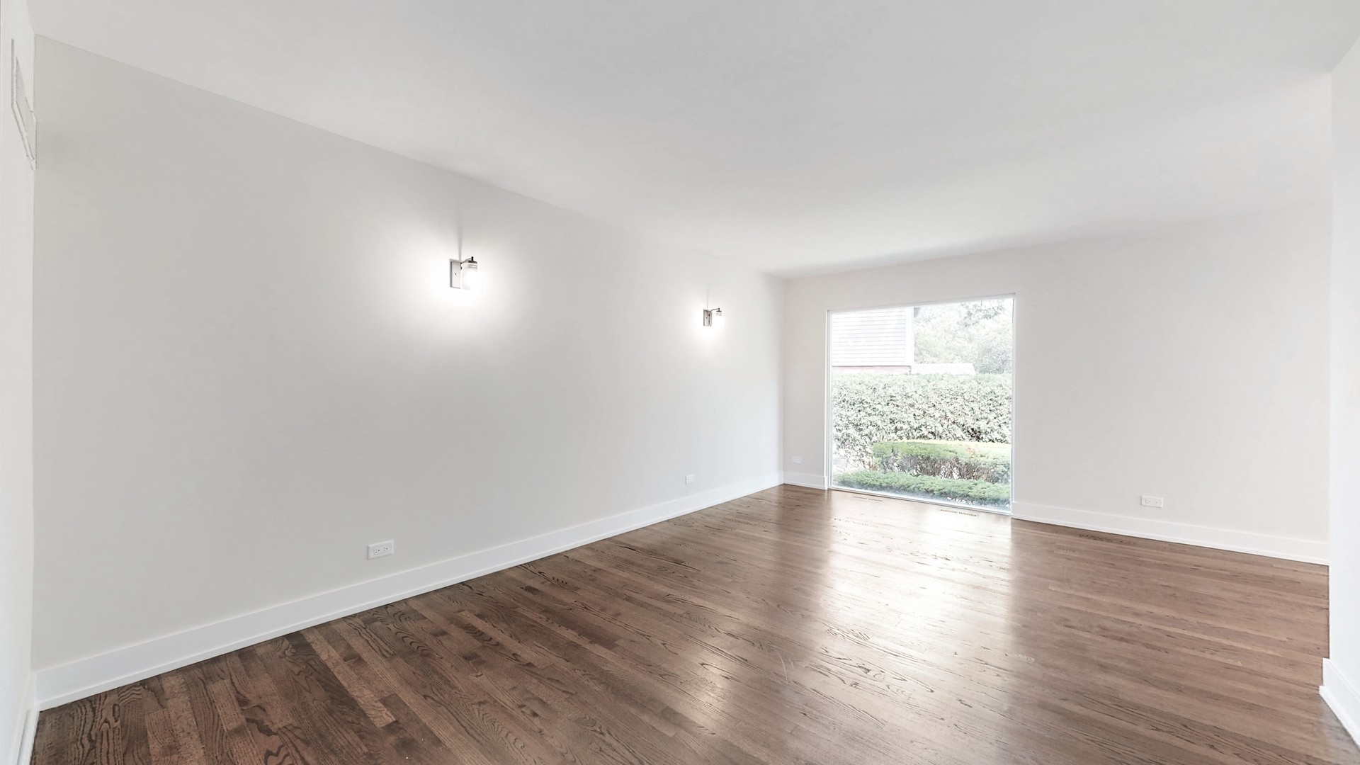 1617 Birch Road Northbrook, IL 60062 - Photo 7 of 32 an empty room with wooden floor and windows