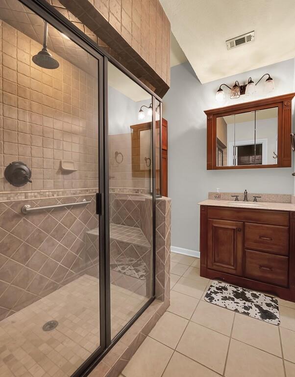 2300 North Rock Creek Road Waco, TX 76708 - Photo 18 of 40 a bathroom with a granite countertop sink a mirror and shower