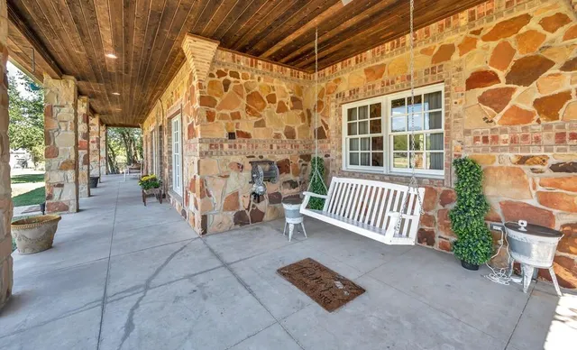 a view of a porch with a chairs and table in a patio