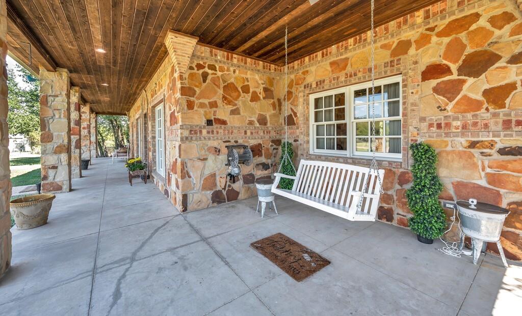 2300 North Rock Creek Road Waco, TX 76708 - Photo 5 of 40 a view of a porch with a chairs and table in a patio