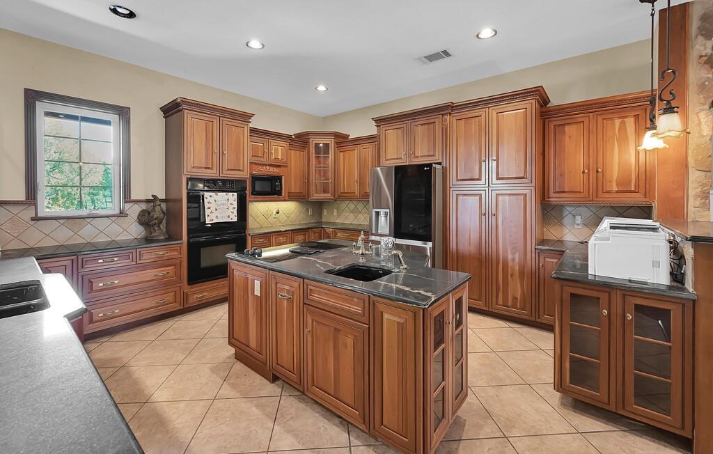 2300 North Rock Creek Road Waco, TX 76708 - Photo 7 of 40 a kitchen with stainless steel appliances granite countertop a stove a sink and a refrigerator