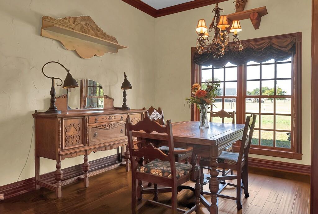 2300 North Rock Creek Road Waco, TX 76708 - Photo 9 of 40 a dining room with furniture a chandelier and wooden floor