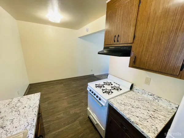 a room with refrigerator and mirror