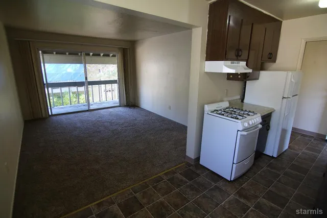 a bathroom with a granite countertop sink toilet and a mirror