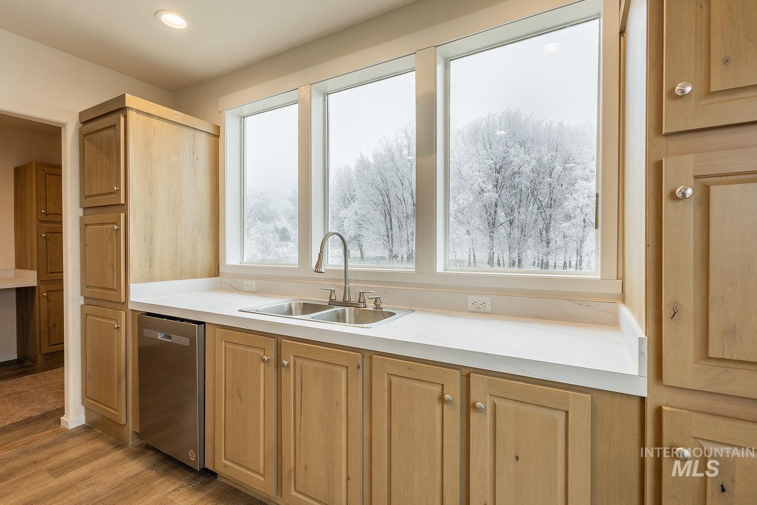 21568 Market Road Parma, ID 83660 - Photo 19 of 22 Kitchen with dishwasher, light countertops, and light wood-type flooring