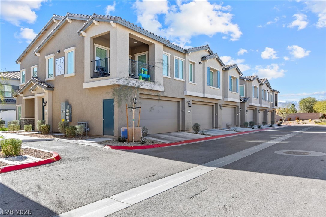 7310 North Decatur Boulevard, Unit 4 North Las Vegas, NV 89084 - Photo 25 of 35 These modern townhomes feature attached garages and private balconies, offering comfortable, convenient living.