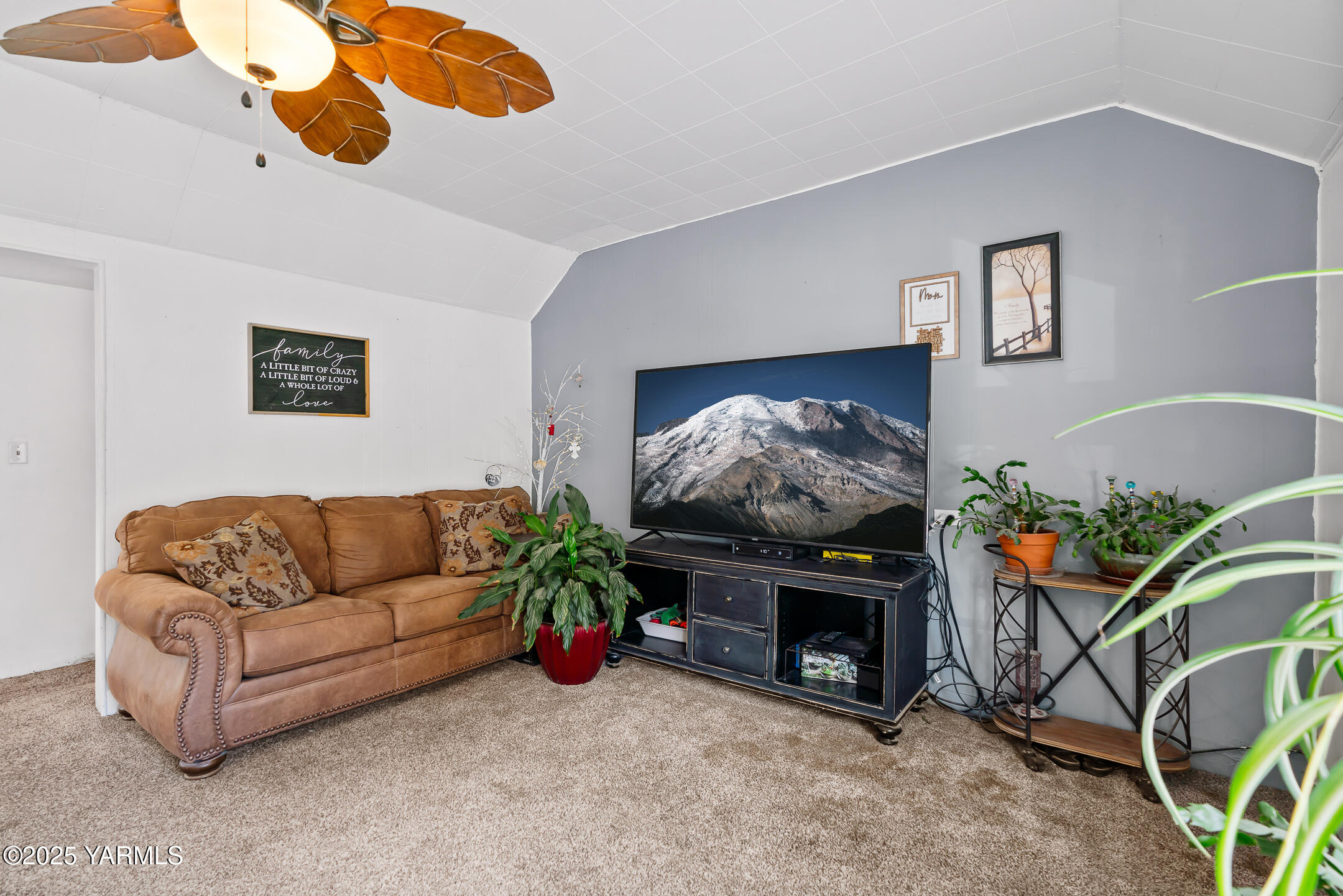 2301 North Wenas Road Selah, WA 98942 - Photo 7 of 25 a living room with furniture a fireplace and a flat screen tv