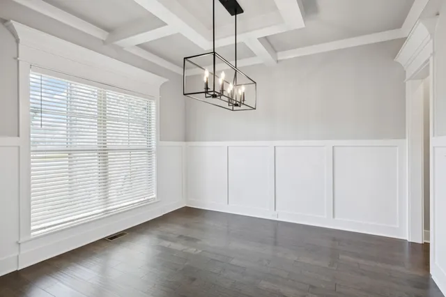 a view of a livingroom with a fireplace wooden floor and windows