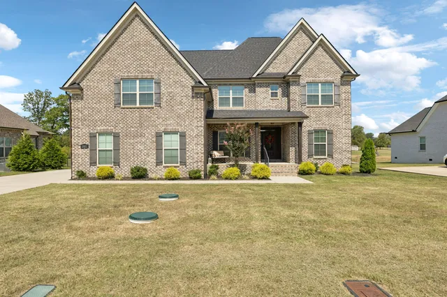 a front view of a house with swimming pool and porch