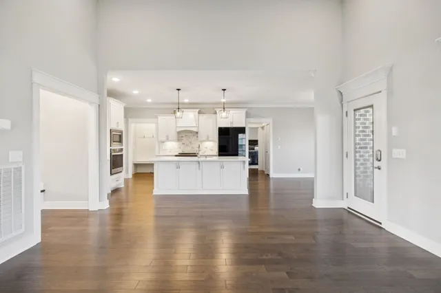 a spacious bedroom with a bed and a ceiling fan