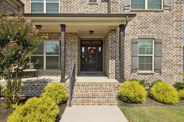a view of a brick wall with a outdoor seating