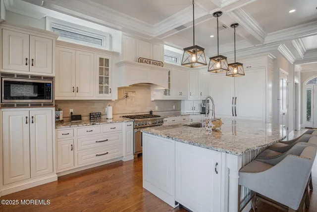 a kitchen with a stove cabinets and a wooden floor