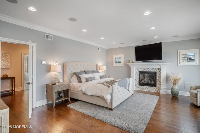 a spacious bedroom with a bed and a fireplace