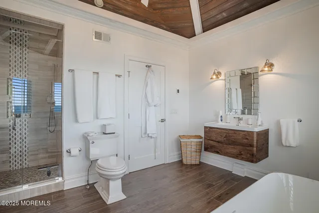 a bathroom with a sink a toilet and shower