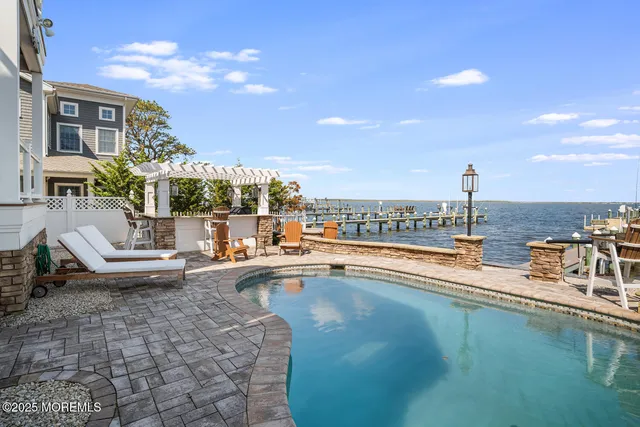 a view of a swimming pool with outdoor seating