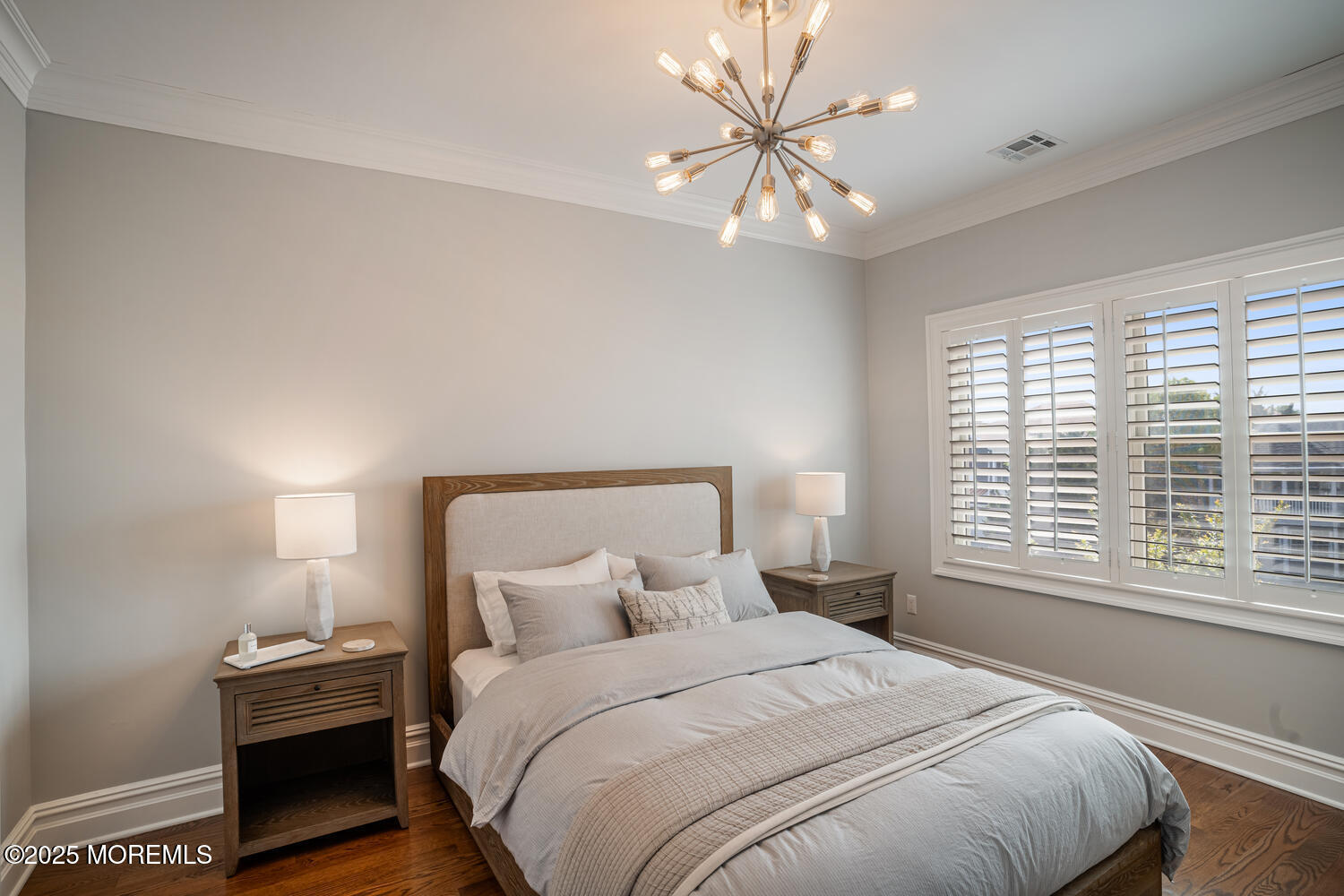47 Pershing Boulevard Lavallette, NJ 08735 - Photo 4 of 44 a bedroom with a large bed and a chandelier