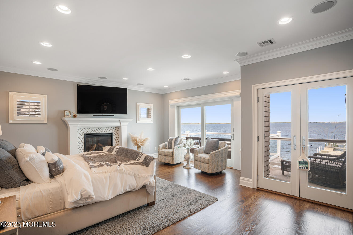 47 Pershing Boulevard Lavallette, NJ 08735 - Photo 5 of 44 a living room with furniture a fireplace and a flat screen tv