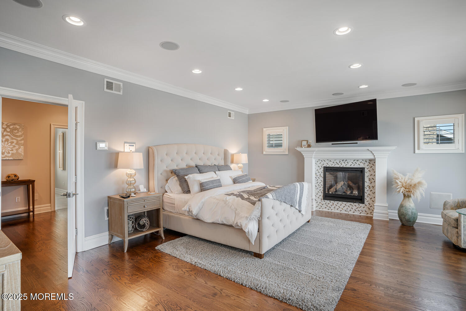 47 Pershing Boulevard Lavallette, NJ 08735 - Photo 6 of 44 a spacious bedroom with a bed and a fireplace