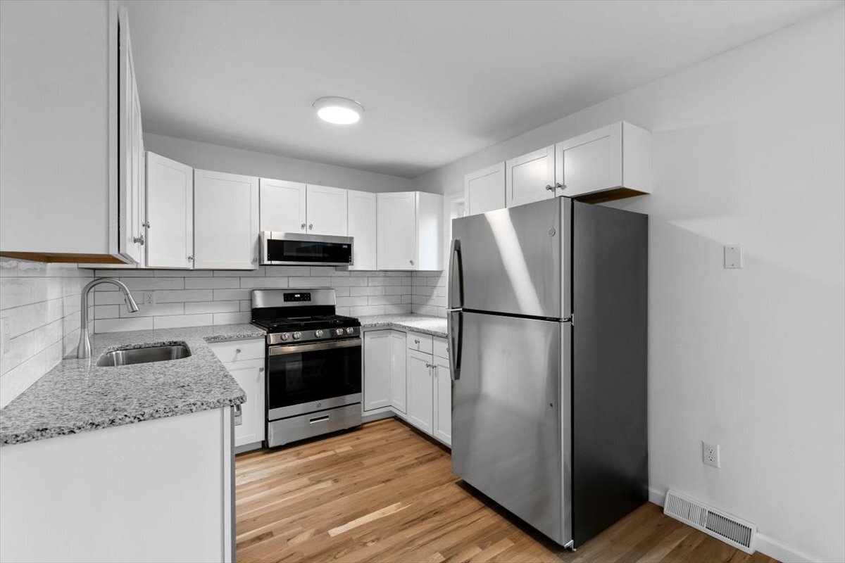204 New Haven Avenue, Unit 2G Derby, CT 06418 - Photo 11 of 24 a kitchen with granite countertop stainless steel appliances a refrigerator and a sink