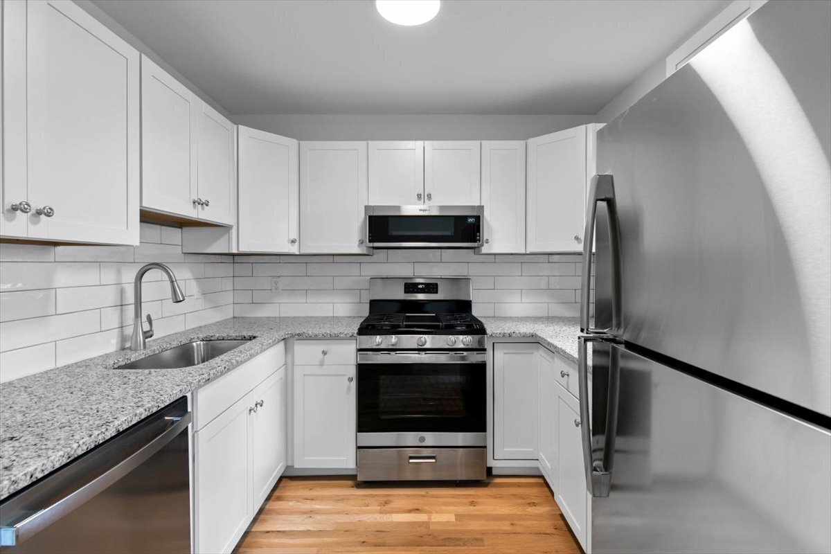 204 New Haven Avenue, Unit 2G Derby, CT 06418 - Photo 13 of 24 a kitchen with granite countertop a stove sink and refrigerator