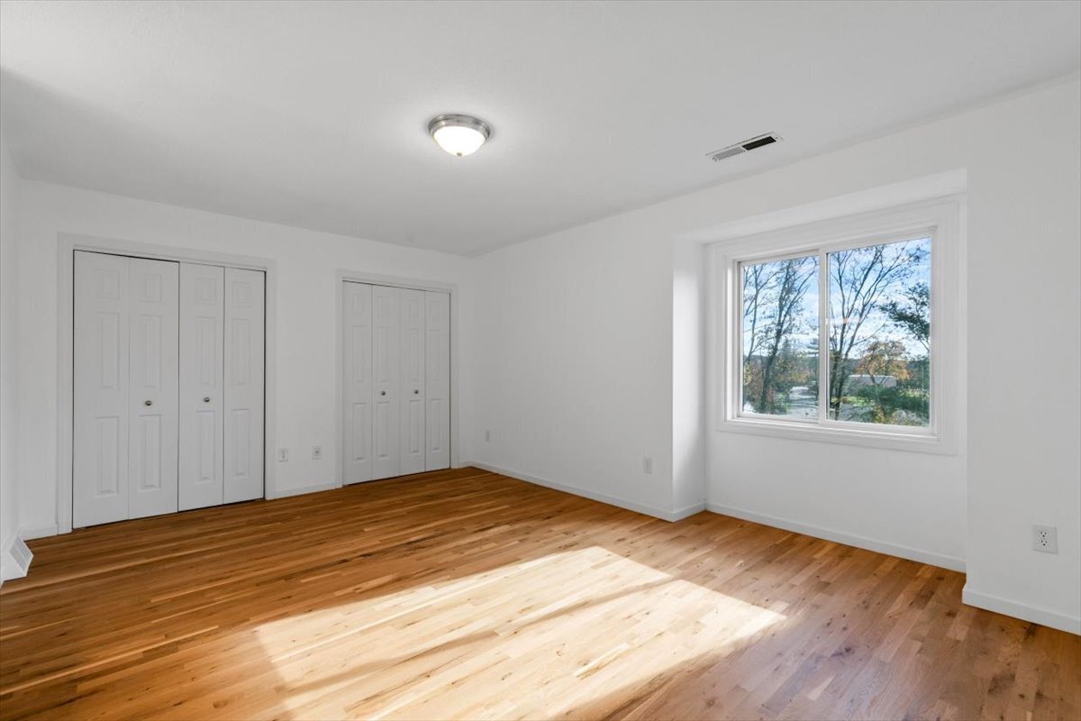 204 New Haven Avenue, Unit 2G Derby, CT 06418 - Photo 17 of 24 a view of empty room with wooden floor and fan