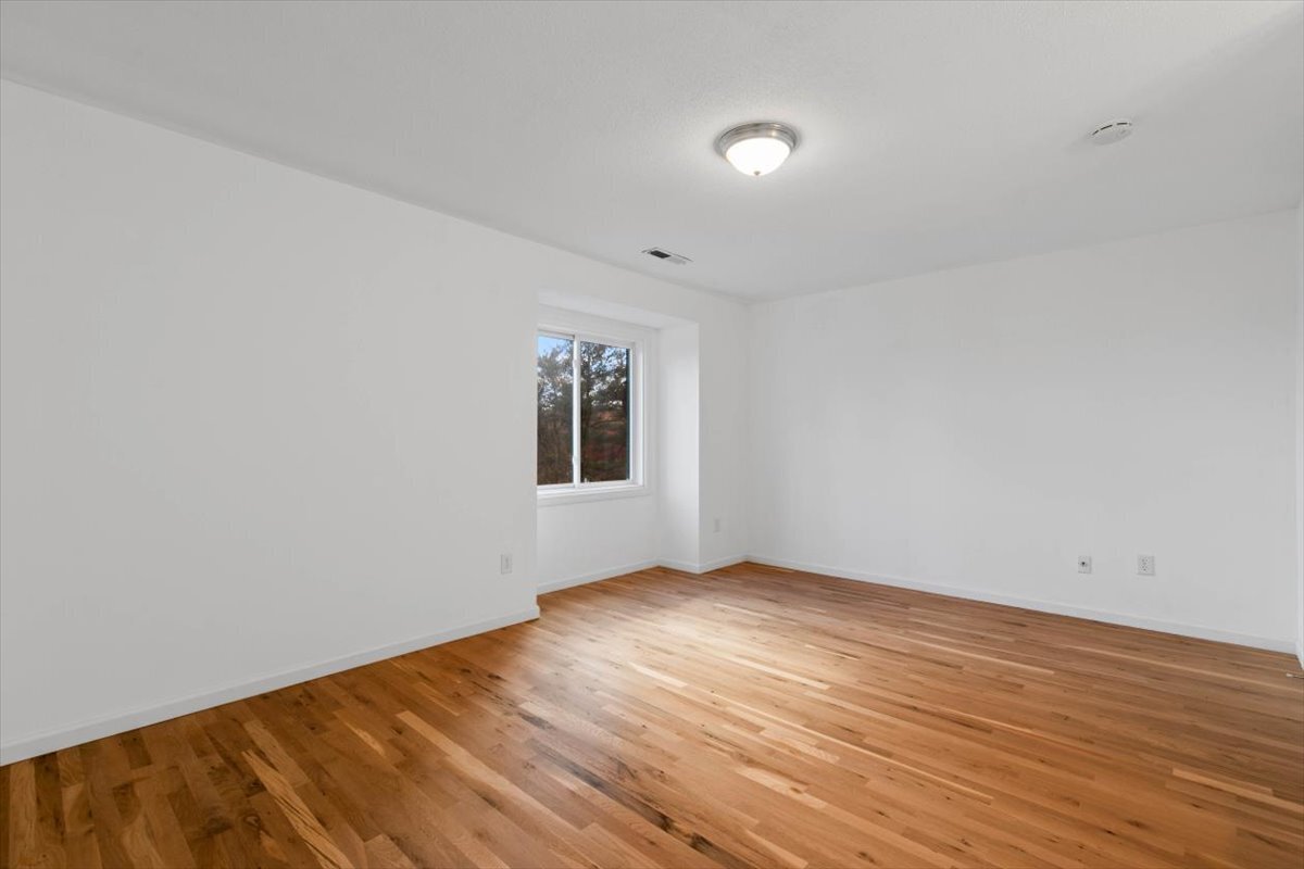 204 New Haven Avenue, Unit 2G Derby, CT 06418 - Photo 20 of 24 a view of an empty room with wooden floor and a window
