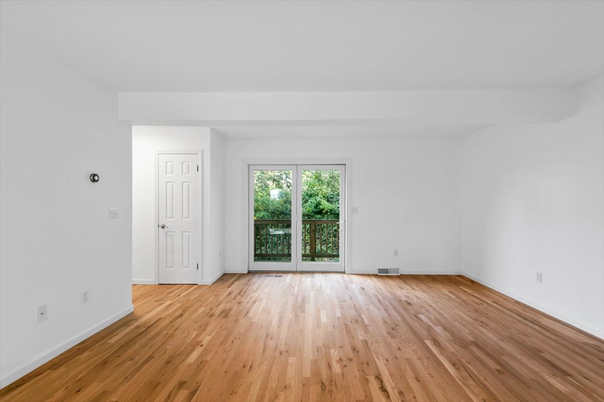 204 New Haven Avenue, Unit 2G Derby, CT 06418 - Photo 2 of 24 an empty room with wooden floor and windows