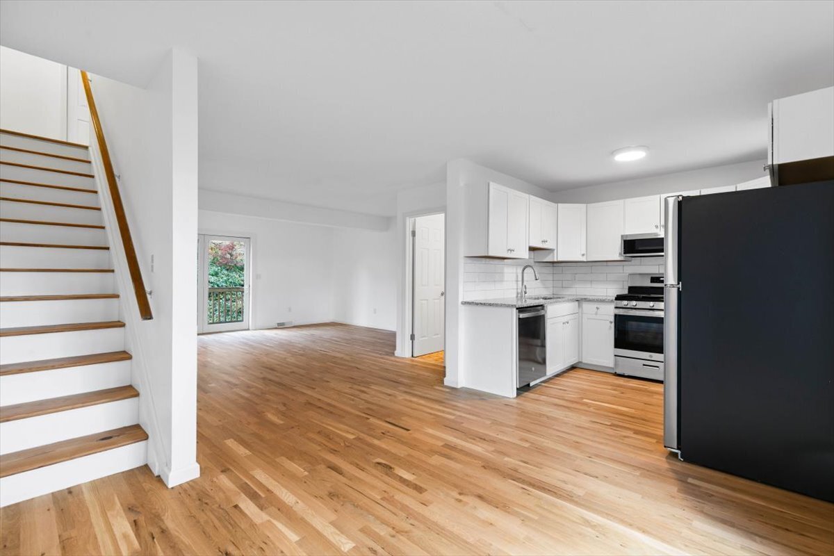 204 New Haven Avenue, Unit 2G Derby, CT 06418 - Photo 4 of 24 a kitchen with kitchen island wooden floors appliances and cabinets