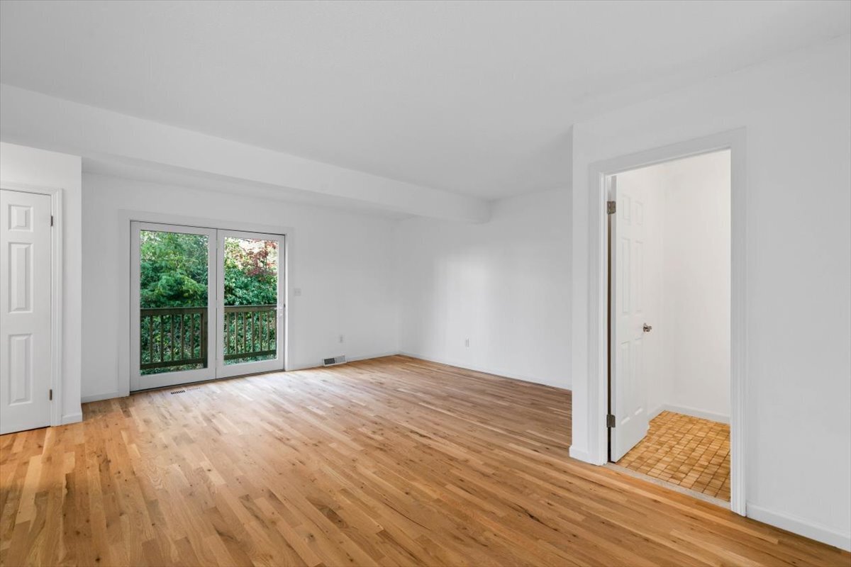 204 New Haven Avenue, Unit 2G Derby, CT 06418 - Photo 6 of 24 a view of an empty room with wooden floor and a window