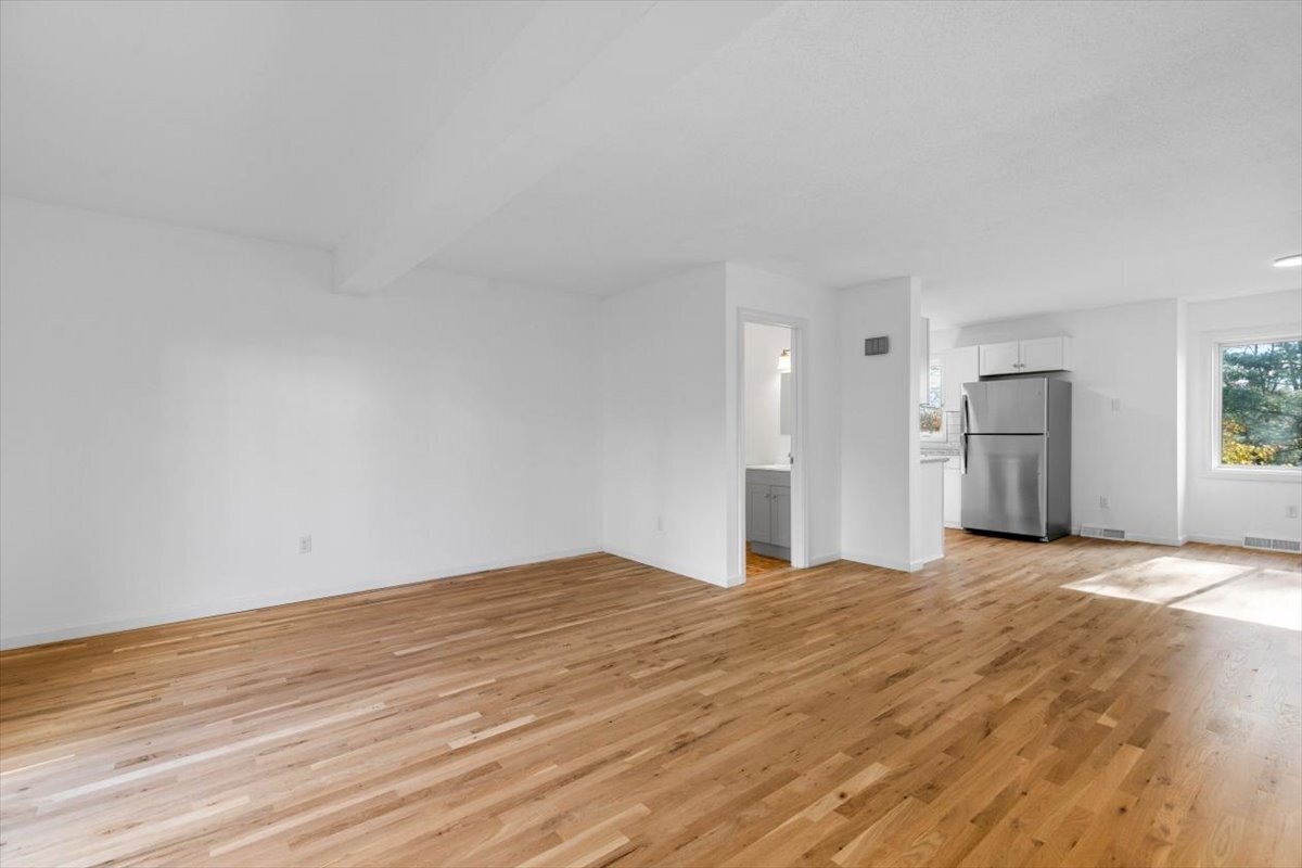 204 New Haven Avenue, Unit 2G Derby, CT 06418 - Photo 9 of 24 a view of empty room with wooden floor and window