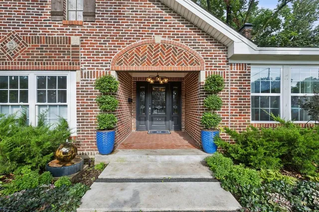 a front view of a house with garden