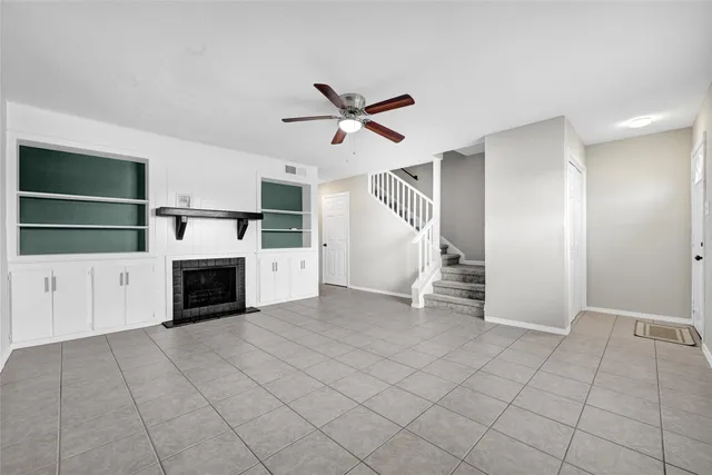 a view of a livingroom with an empty space and a kitchen
